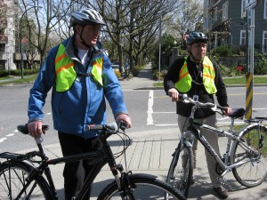 cycle chic adherents heard screaming "you're doing it wrong" as local politicians mix modern street clothes with traditional 'cyclist' garb including ceremonial headdresses and hi-viz  vests